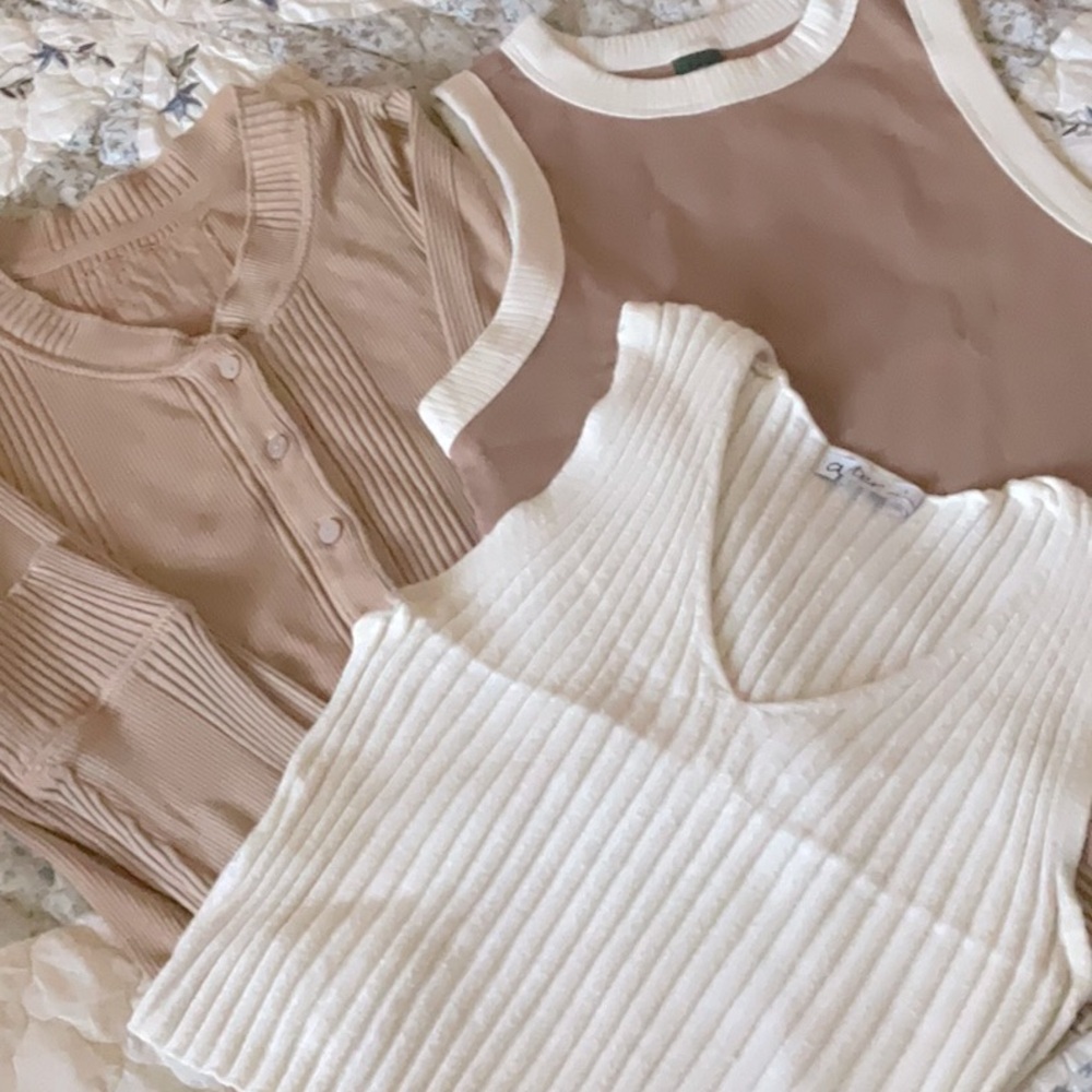 Bundle of tan, brown, and white tees